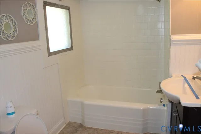 a bathroom with a sink a toilet and bathtub