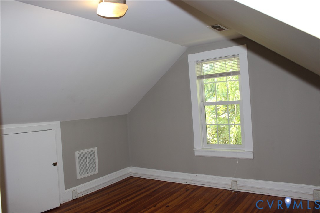 2411 West City Point Road Hopewell, VA 23860 - Photo 6 of 11 a view of an empty room with wooden floor and a window
