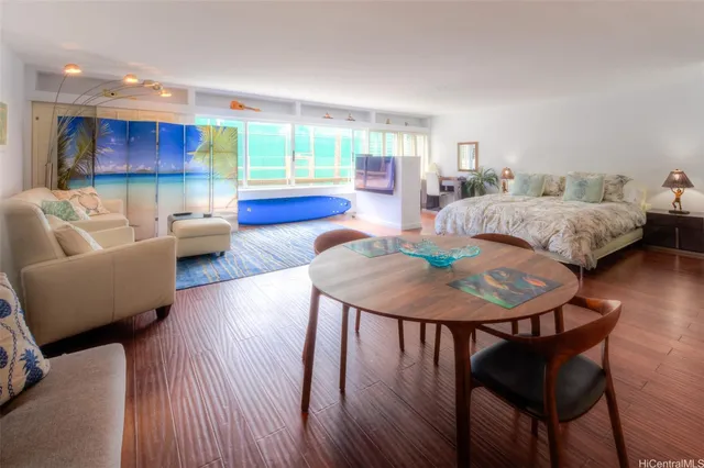 a living room with furniture and a wooden floor