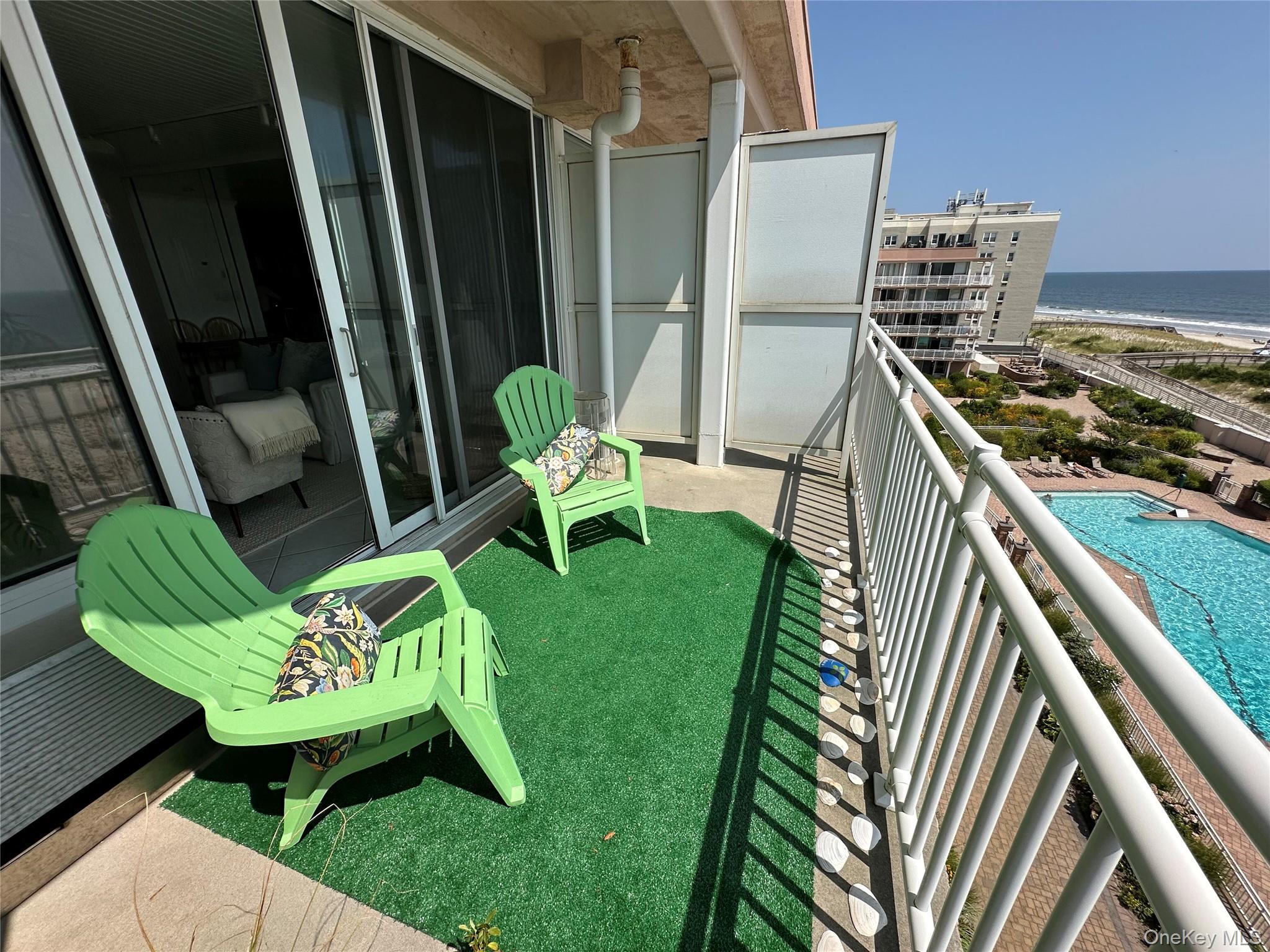 830 Shore Road, Unit 5T Long Beach, NY 11561 - Photo 13 of 18 a backyard of a house with table and chairs