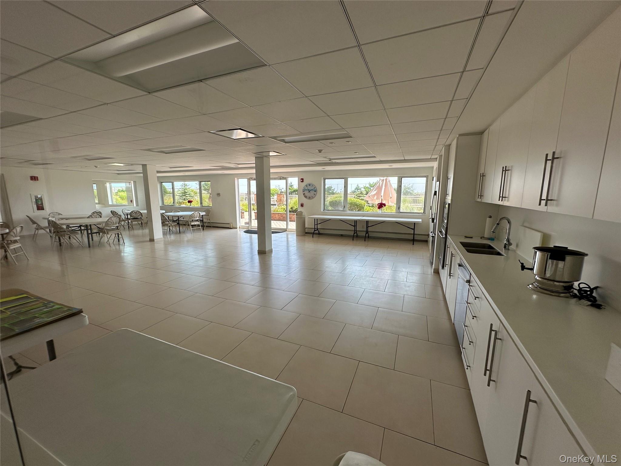 830 Shore Road, Unit 5T Long Beach, NY 11561 - Photo 15 of 18 a bathroom with a sink a large mirror and a window