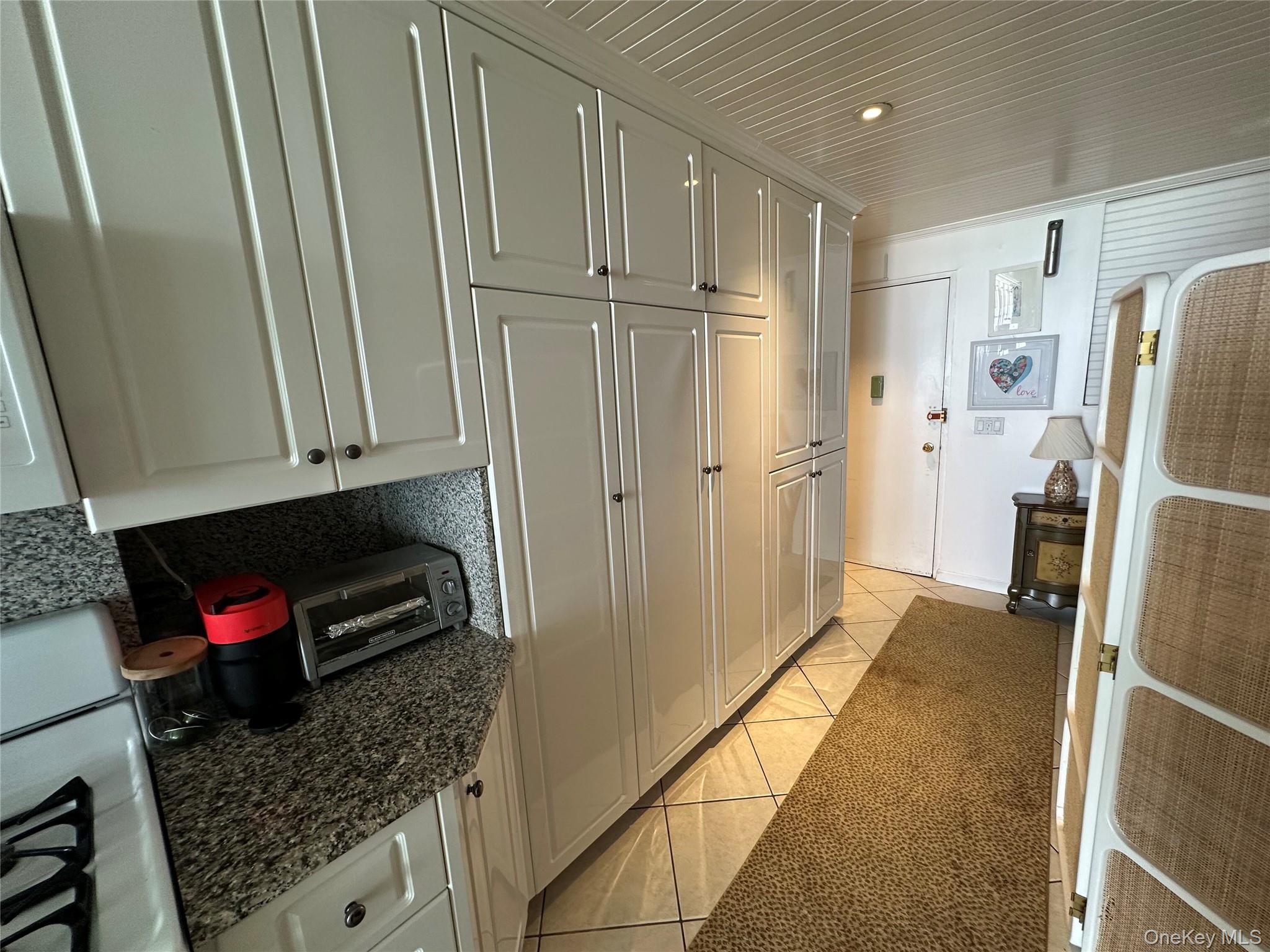 830 Shore Road, Unit 5T Long Beach, NY 11561 - Photo 2 of 18 a kitchen with refrigerator and cabinets