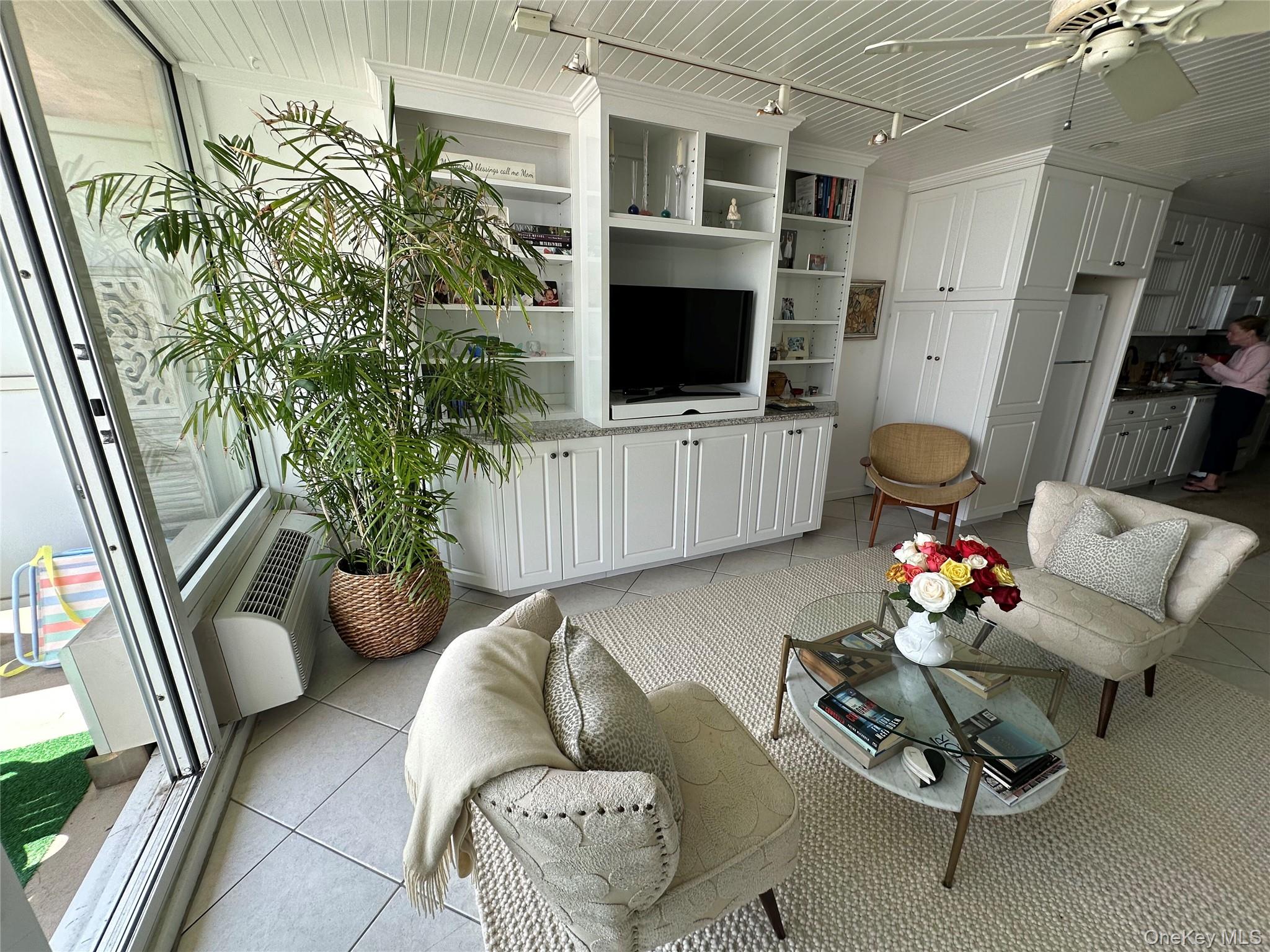 830 Shore Road, Unit 5T Long Beach, NY 11561 - Photo 5 of 18 a living room with furniture and a flat screen tv