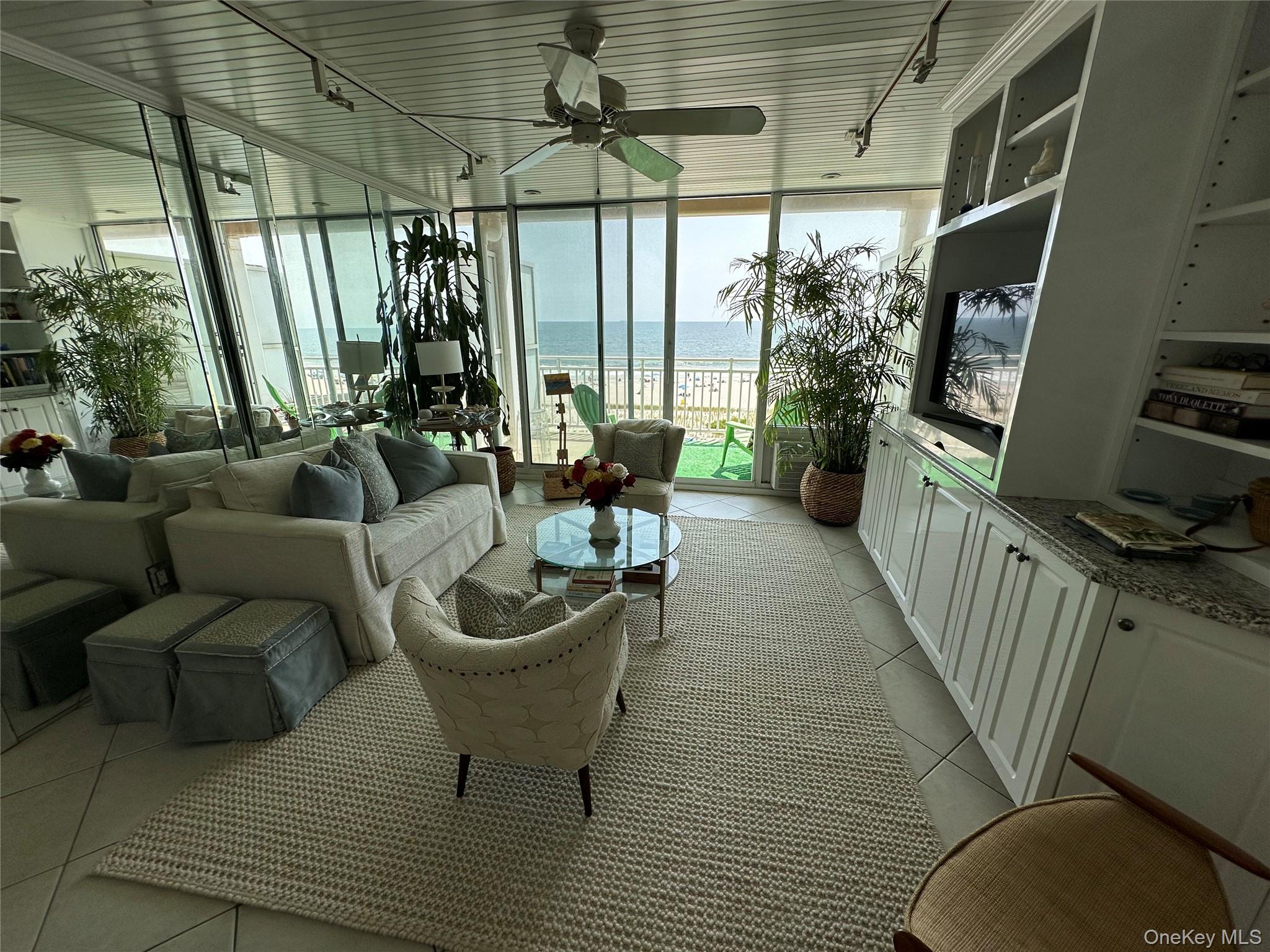 830 Shore Road, Unit 5T Long Beach, NY 11561 - Photo 8 of 18 a living room with furniture and a large window