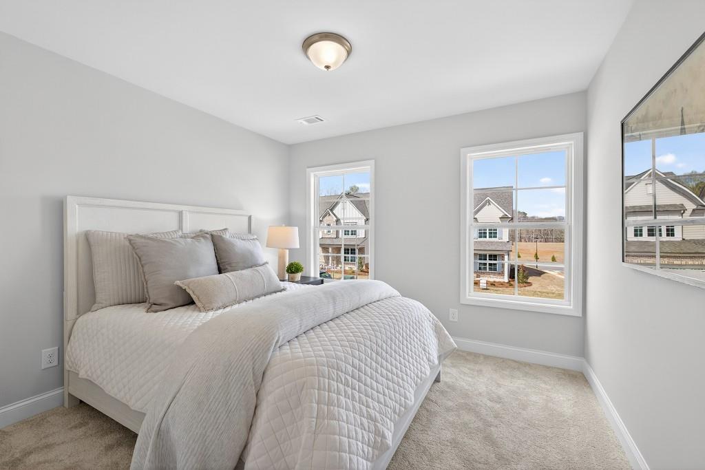 2789 Apperson Way Suwanee, GA 30024 - Photo 14 of 37 a bedroom with a large bed and a window