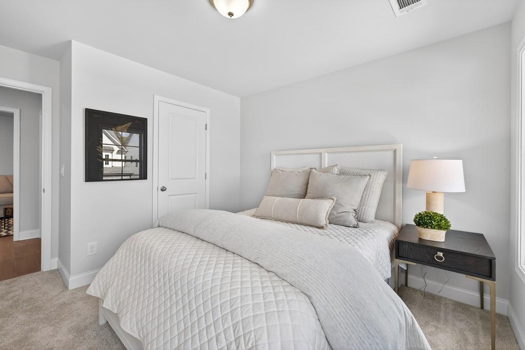 2789 Apperson Way Suwanee, GA 30024 - Photo 15 of 37 a bedroom with a bed and a lamp on table