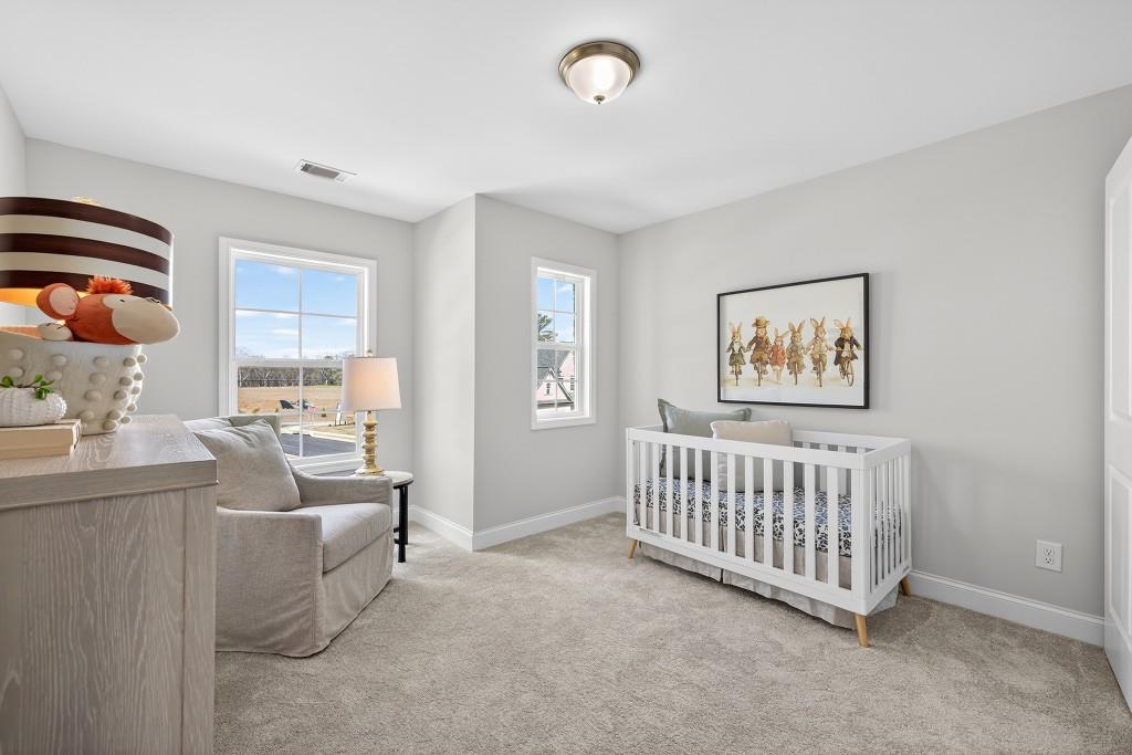 2789 Apperson Way Suwanee, GA 30024 - Photo 16 of 37 a living room with furniture a baby crib and a window
