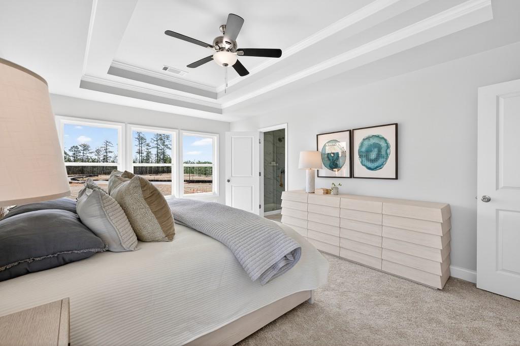 2789 Apperson Way Suwanee, GA 30024 - Photo 18 of 37 a bedroom with a large bed and a chandelier