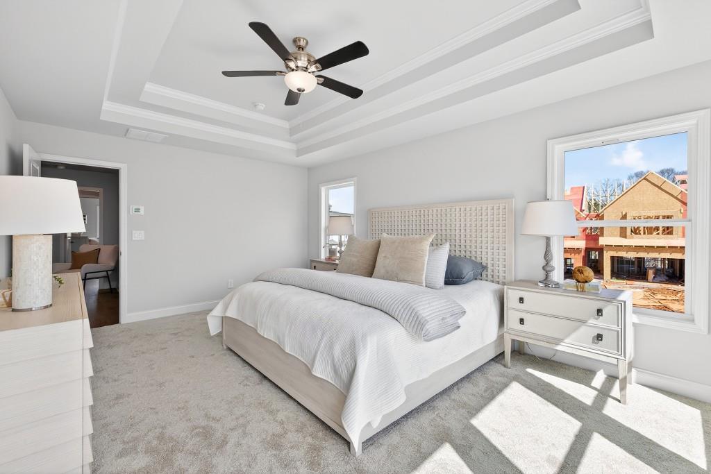 2789 Apperson Way Suwanee, GA 30024 - Photo 19 of 37 a bedroom with a large bed and a chandelier