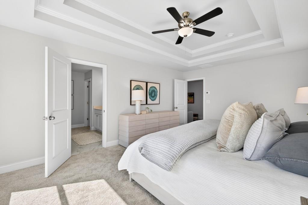 2789 Apperson Way Suwanee, GA 30024 - Photo 20 of 37 a bedroom with a large bed and a ceiling fan