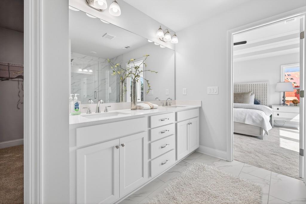 2789 Apperson Way Suwanee, GA 30024 - Photo 22 of 37 a spacious bathroom with a double vanity sink double and mirror