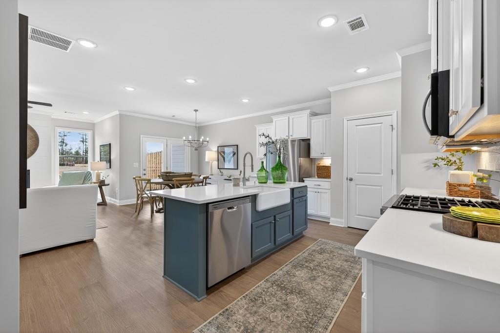 2789 Apperson Way Suwanee, GA 30024 - Photo 3 of 37 a large kitchen with stainless steel appliances kitchen island granite countertop a large counter top and a stove top oven