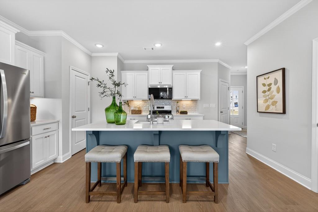 2789 Apperson Way Suwanee, GA 30024 - Photo 4 of 37 a kitchen with refrigerator and chairs