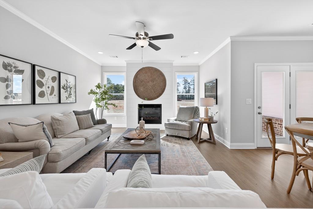 2789 Apperson Way Suwanee, GA 30024 - Photo 5 of 37 a living room with furniture a fireplace and a large window