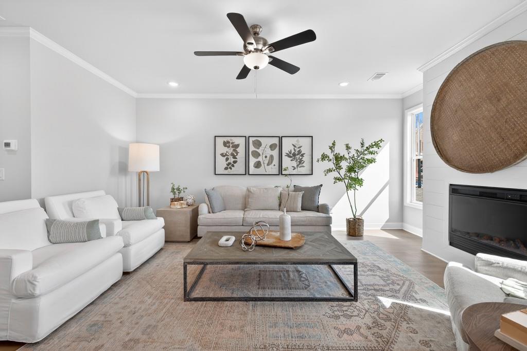 2789 Apperson Way Suwanee, GA 30024 - Photo 6 of 37 a living room with furniture a fireplace and a flat screen tv