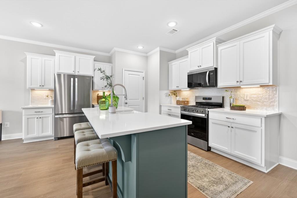 2789 Apperson Way Suwanee, GA 30024 - Photo 10 of 37 a kitchen with refrigerator cabinets and wooden floor
