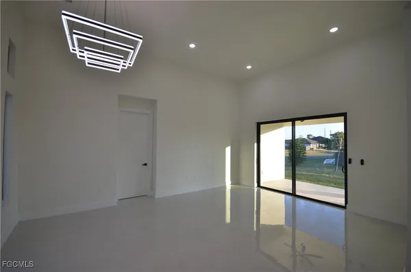 a view of a hallway with a room and stairs