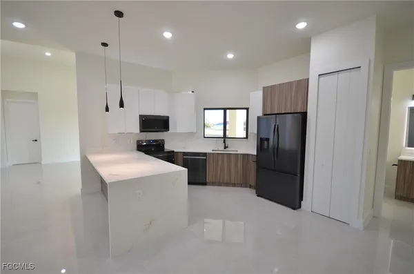 a bathroom with a sink a large mirror and a shower