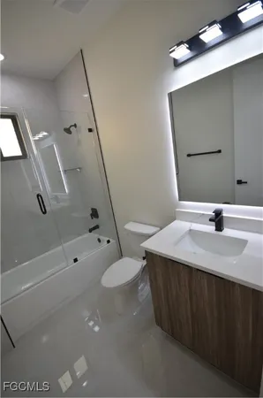 a bathroom with a bathtub a toilet and a shower