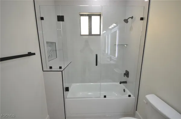 a bathroom with a sink toilet and mirror