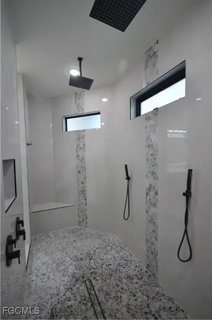a bathroom with a shower and a sink