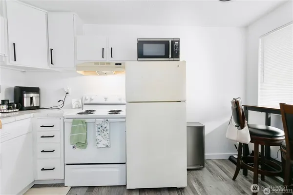 a kitchen with stainless steel appliances a sink a stove and a refrigerator
