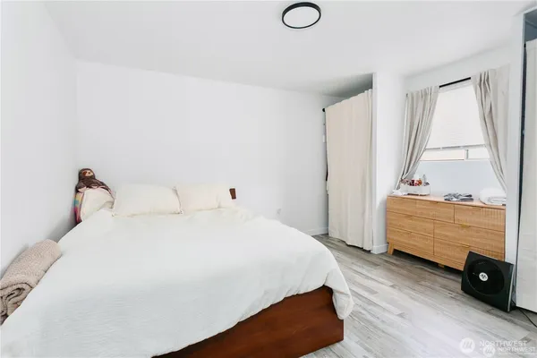 a view of room with wooden floor and white walls