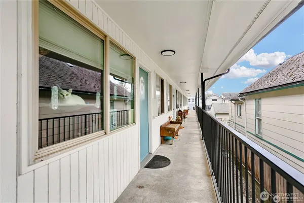 a view of balcony with wooden floor and fence