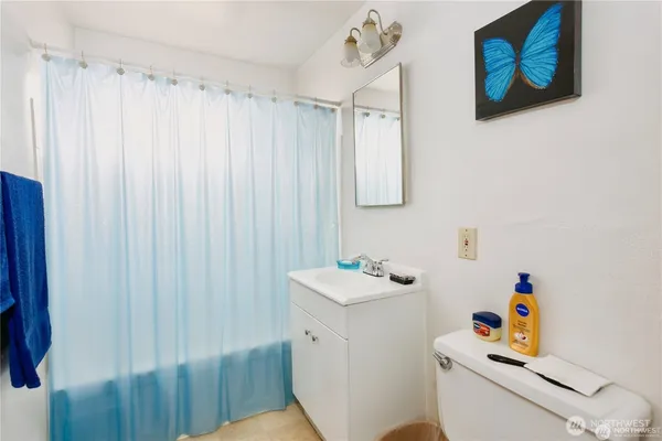 a white kitchen with lots of clutter and cabinets