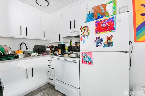 a kitchen with kitchen island a sink cabinets and appliances