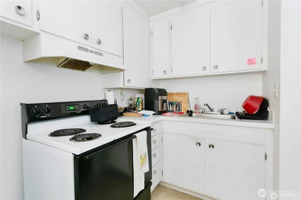 a bathroom with a sink toilet and curtain