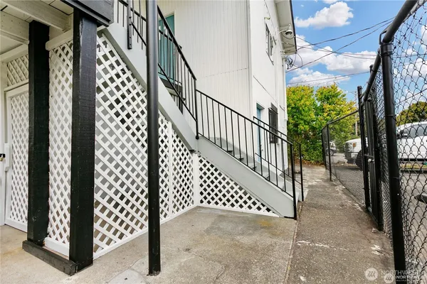 an aerial view of residential houses with outdoor space and parking