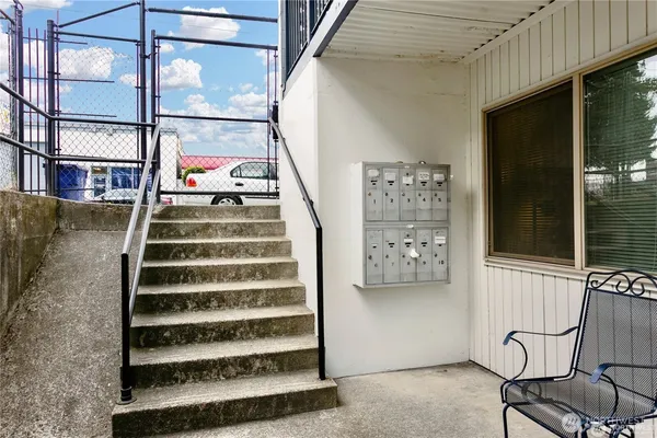 a view of staircase with white walls and windows