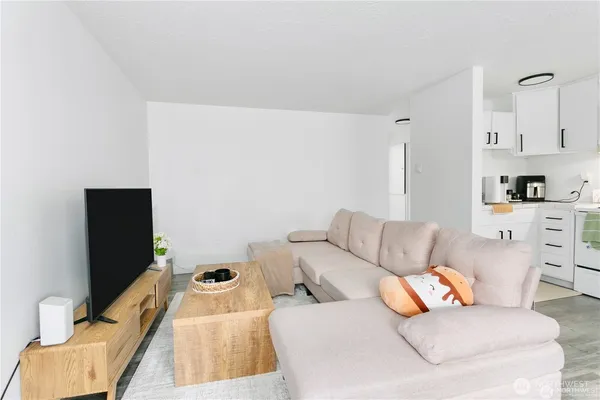 a kitchen with stainless steel appliances white cabinets and wooden floor