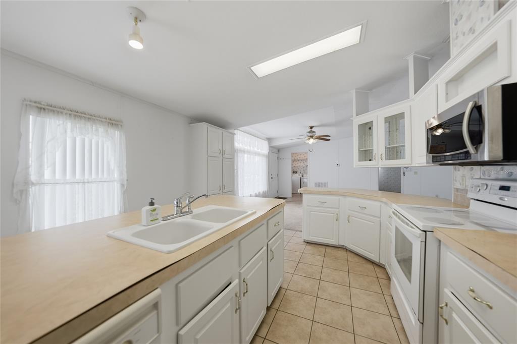 11923 Southwest Loop Terrace Arcadia, FL 34269 - Photo 11 of 50 a kitchen with a sink dishwasher stove and microwave