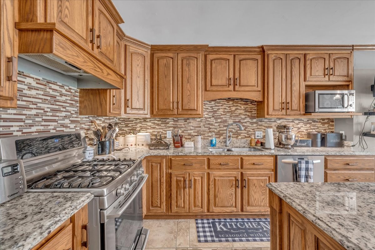 3404 Awalt Road Tullahoma, TN 37388 - Photo 23 of 84 a kitchen with stainless steel appliances granite countertop a stove a sink dishwasher and cabinets with wooden floor
