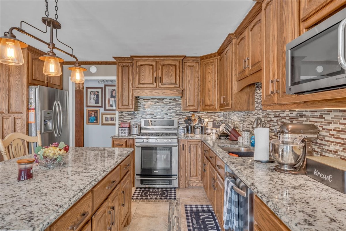 3404 Awalt Road Tullahoma, TN 37388 - Photo 25 of 84 a kitchen with stainless steel appliances granite countertop a sink stove and cabinets