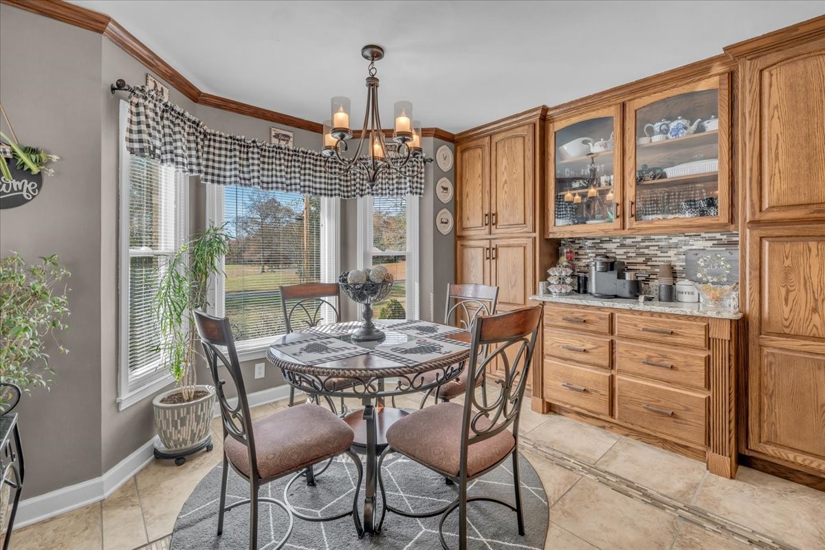 3404 Awalt Road Tullahoma, TN 37388 - Photo 27 of 84 a dining room with furniture a chandelier and wooden floor