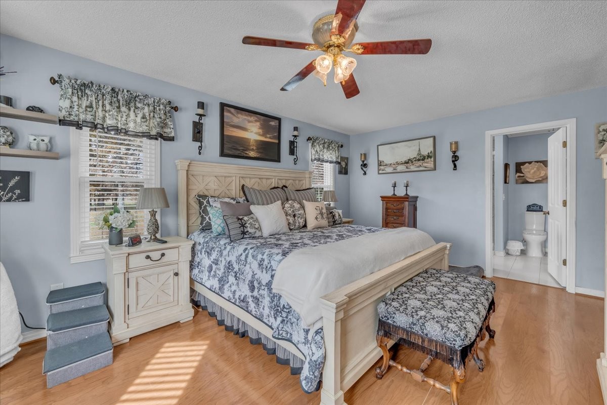 3404 Awalt Road Tullahoma, TN 37388 - Photo 33 of 84 a bedroom with a large bed a flat tv screen and dresser