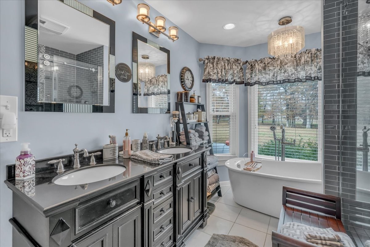 3404 Awalt Road Tullahoma, TN 37388 - Photo 35 of 84 a bathroom with a granite countertop sink a large mirror and a shower