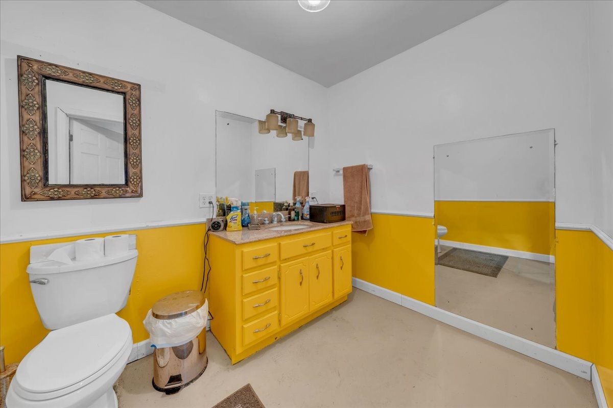 3404 Awalt Road Tullahoma, TN 37388 - Photo 60 of 84 a bathroom with a granite countertop toilet sink and mirror