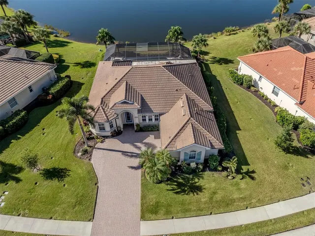 an aerial view of a house with a yard and potted plants