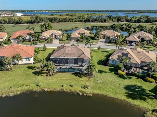 a front view of a house with a garden and trees