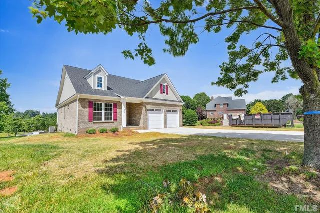 a kitchen with stainless steel appliances granite countertop a sink a stove and a wooden floor