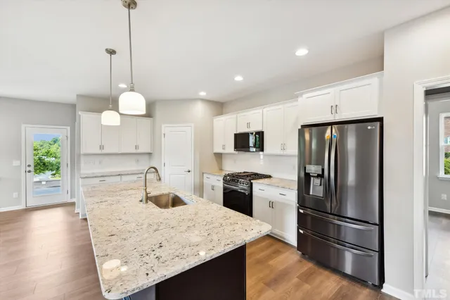 a bathroom with a granite countertop sink a toilet and bathtub