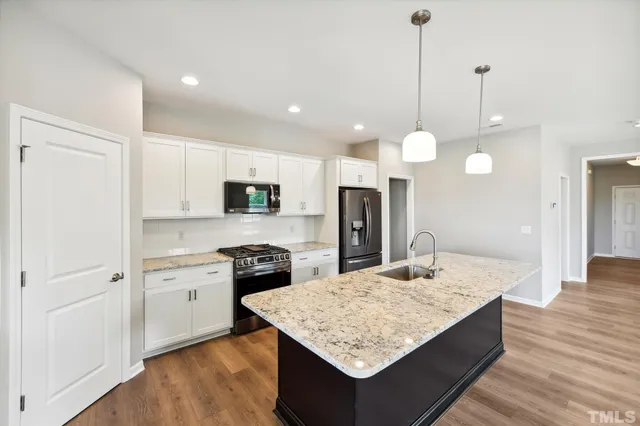 a bathroom with a granite countertop sink and vanity