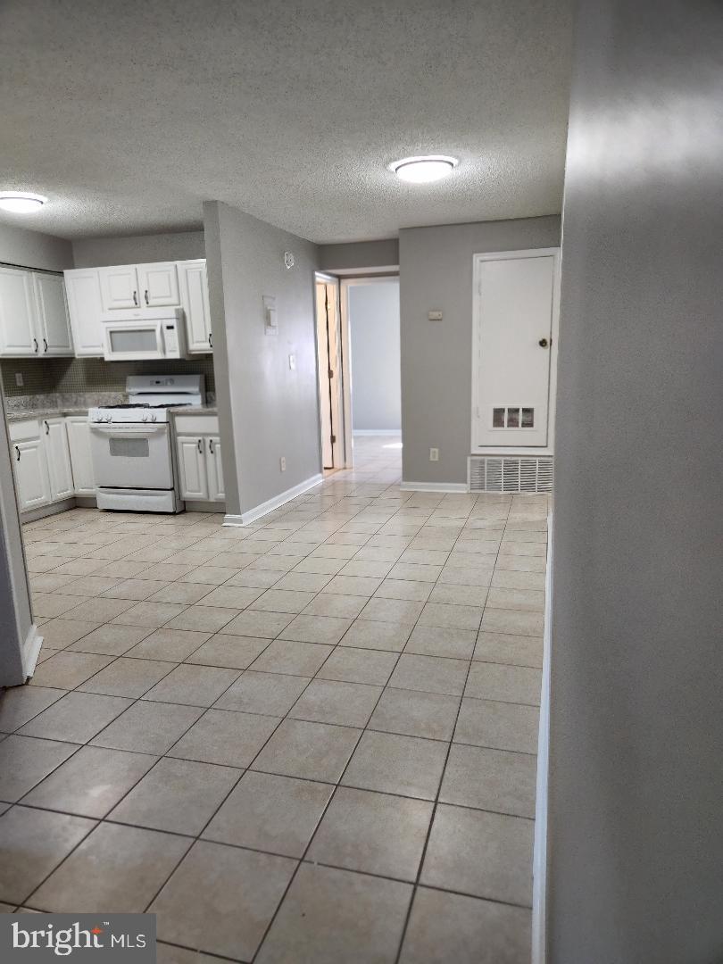 11911 Tarragon Road, Unit A Reisterstown, MD 21136 - Photo 4 of 12 Large dining area. New paint through entire unit.
