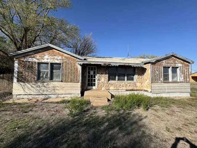 a front view of a house with yard and seating area