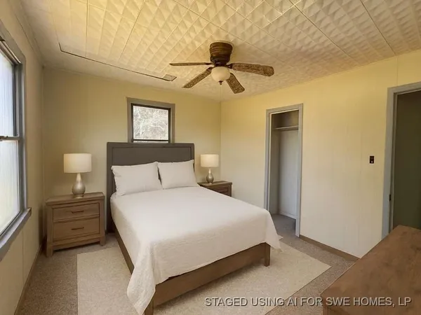 a bedroom with a bed and a painting on the wall