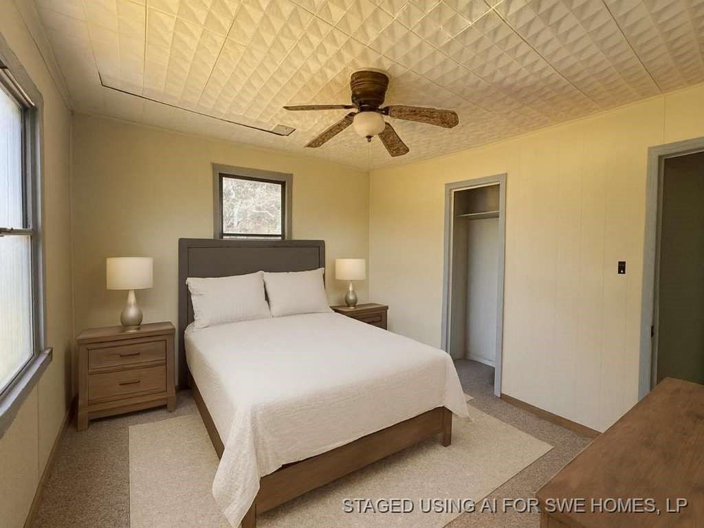 200 West 2nd Street Plainview, TX 79072 - Photo 6 of 7 a bedroom with a bed and a painting on the wall